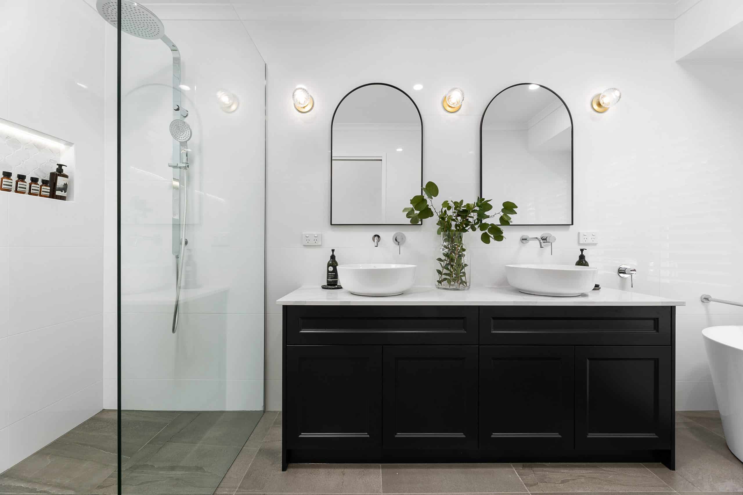 White bathroom with black vanity unit