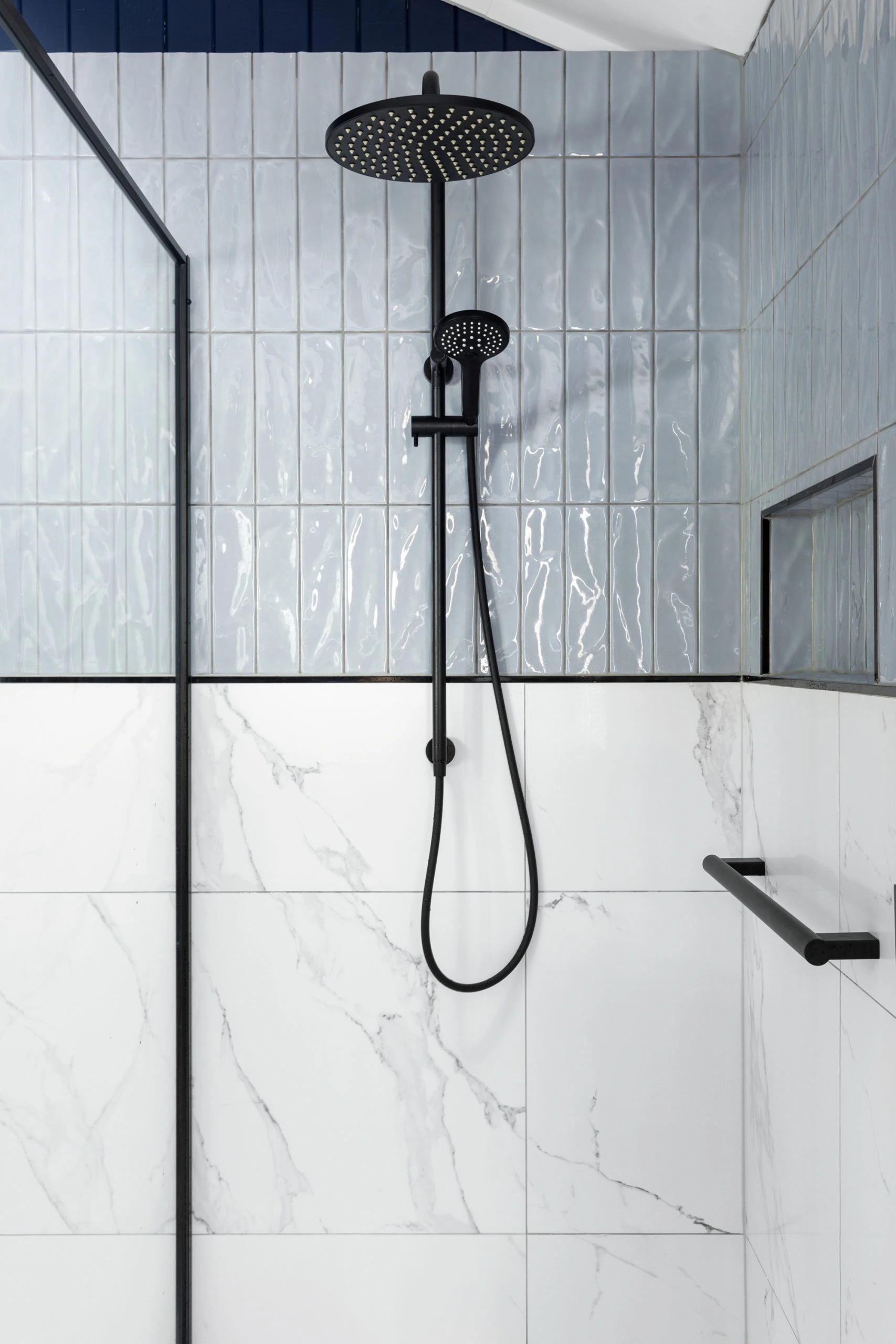 Mixed bathroom tiles in a modern bathroom with black details
