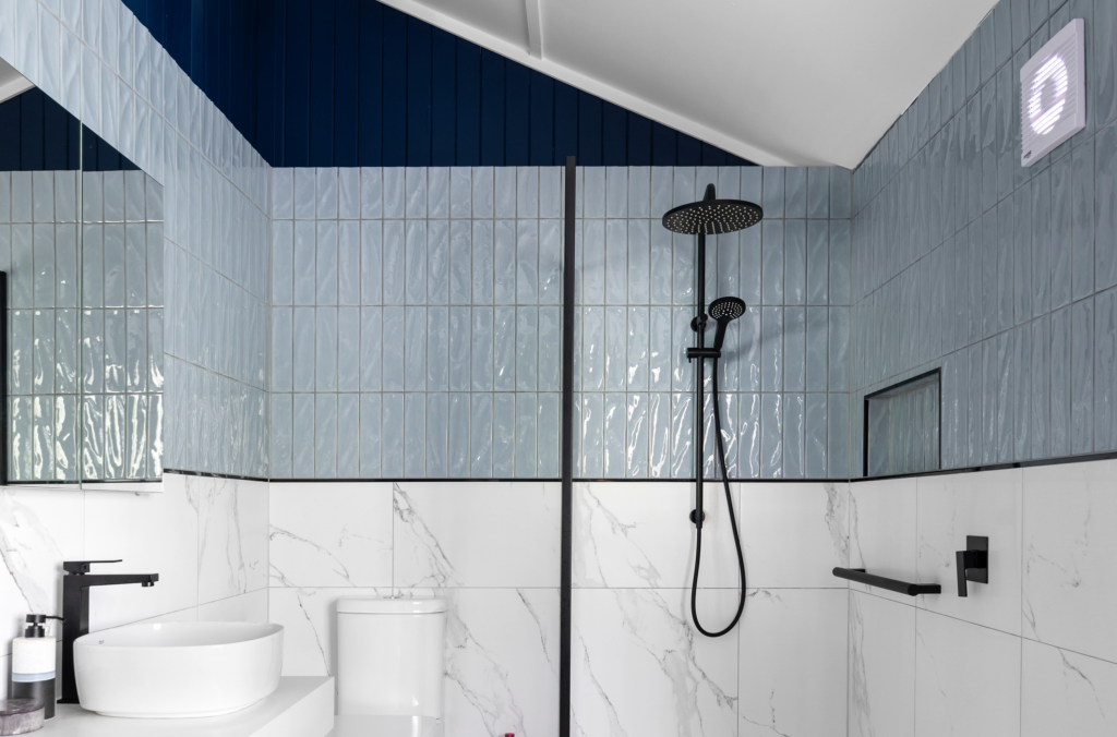 Mixed bathroom tiles in a modern bathroom with black details