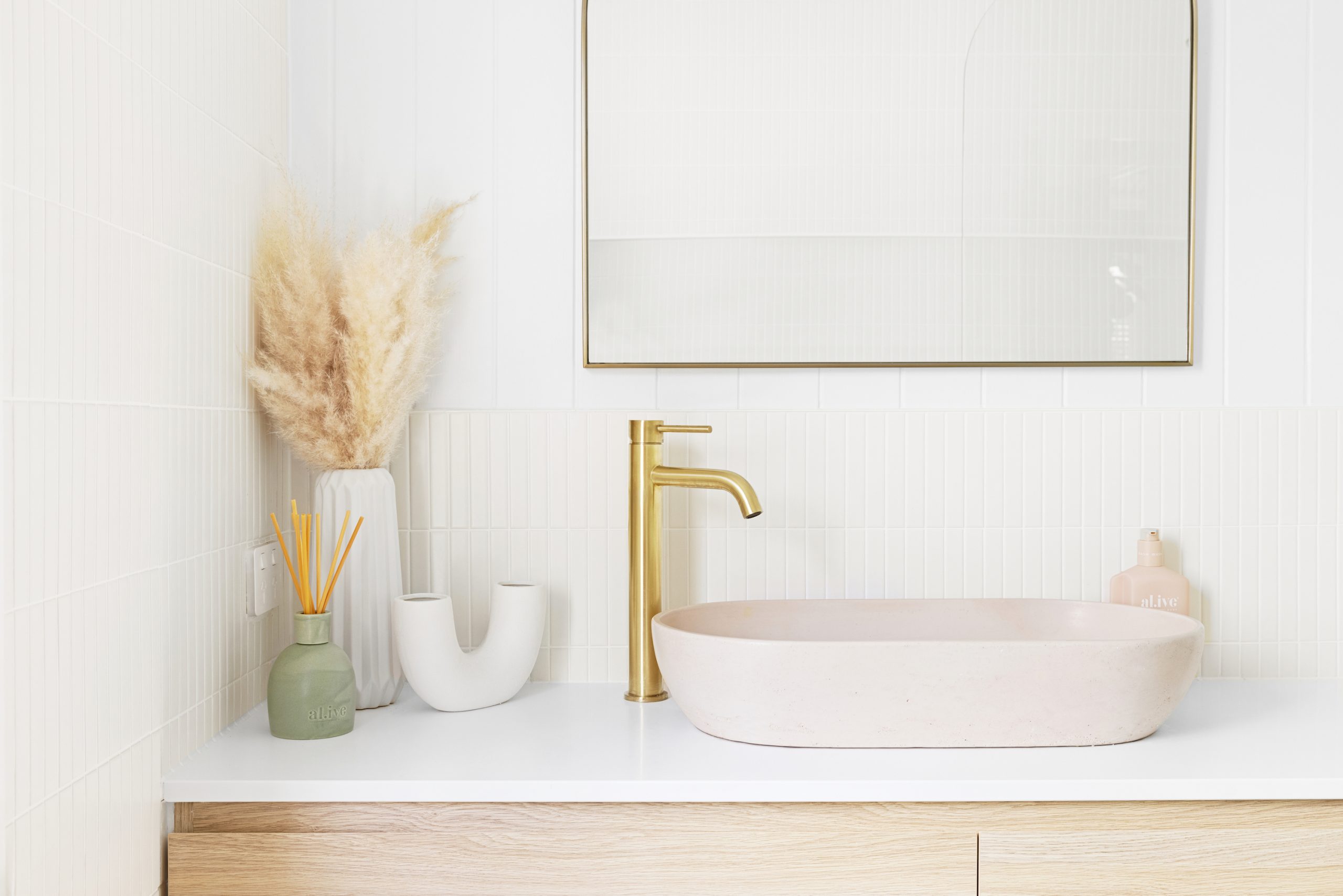 Modern wooden bathroom vanity with gold taps