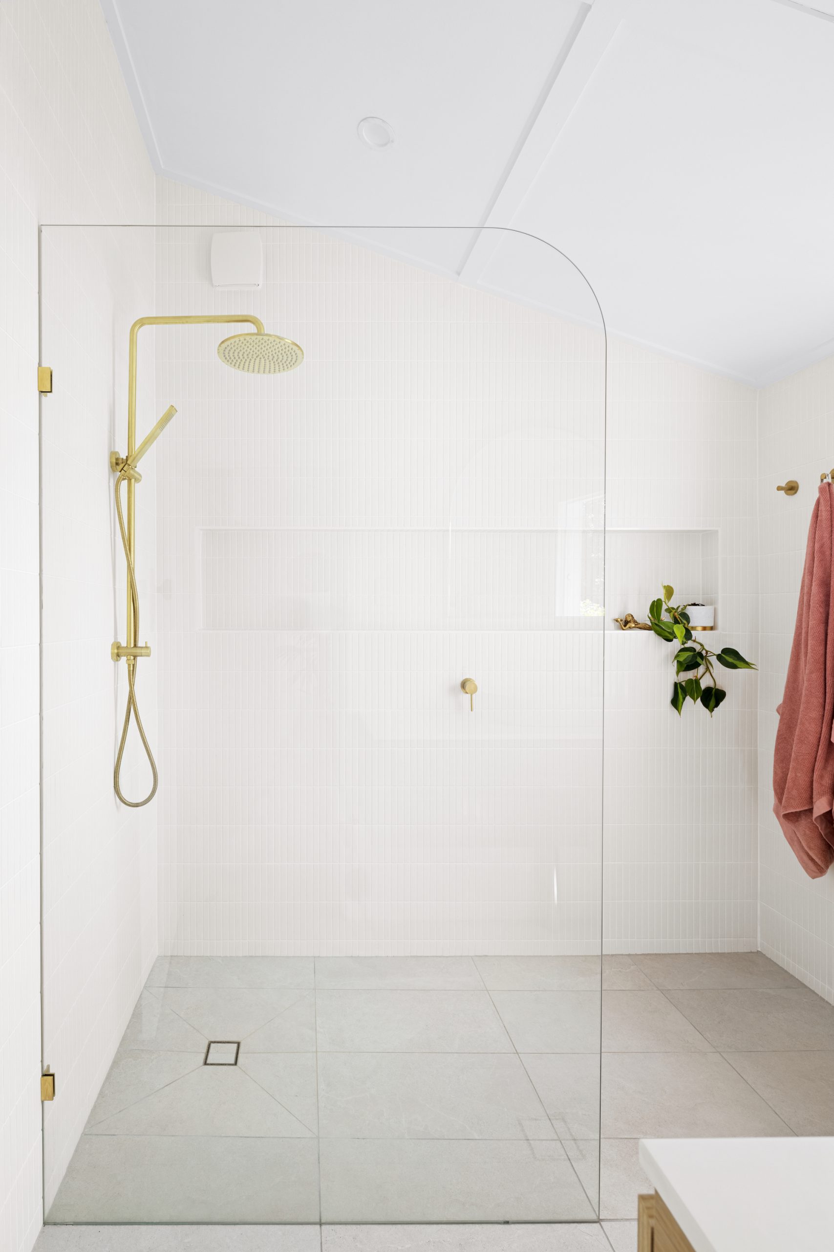transparent bathroom divider with gold coloured shower
