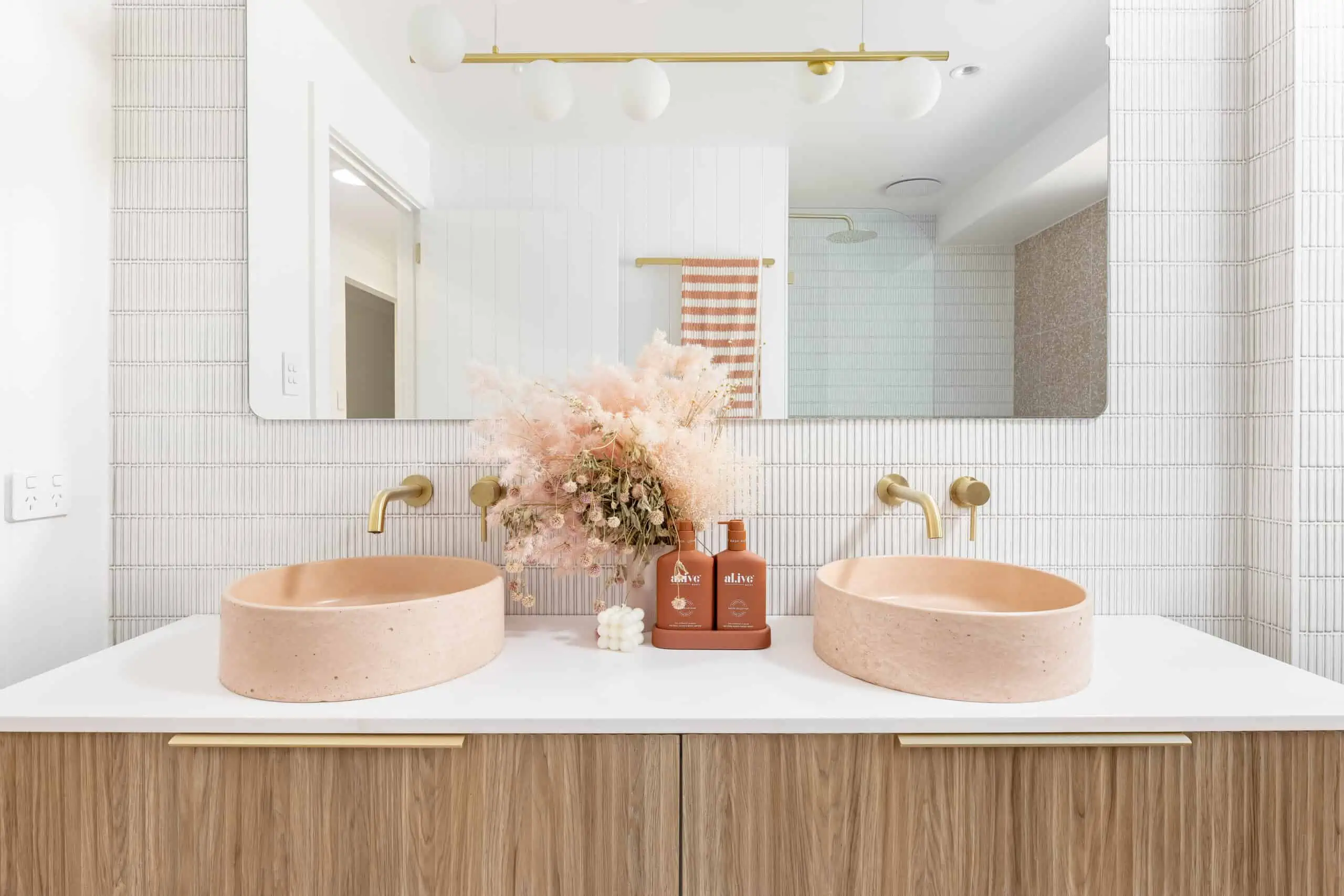 Blush pink, gold and white aesthetic in a bathroom renovation. Shot of the vanity unit.