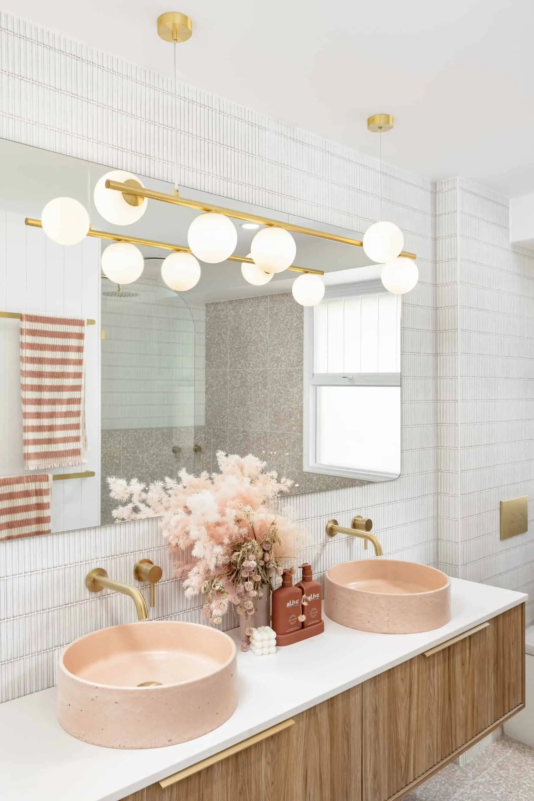 His and hers blush pink sinks on a modern vanity unit in a bathroom renovation