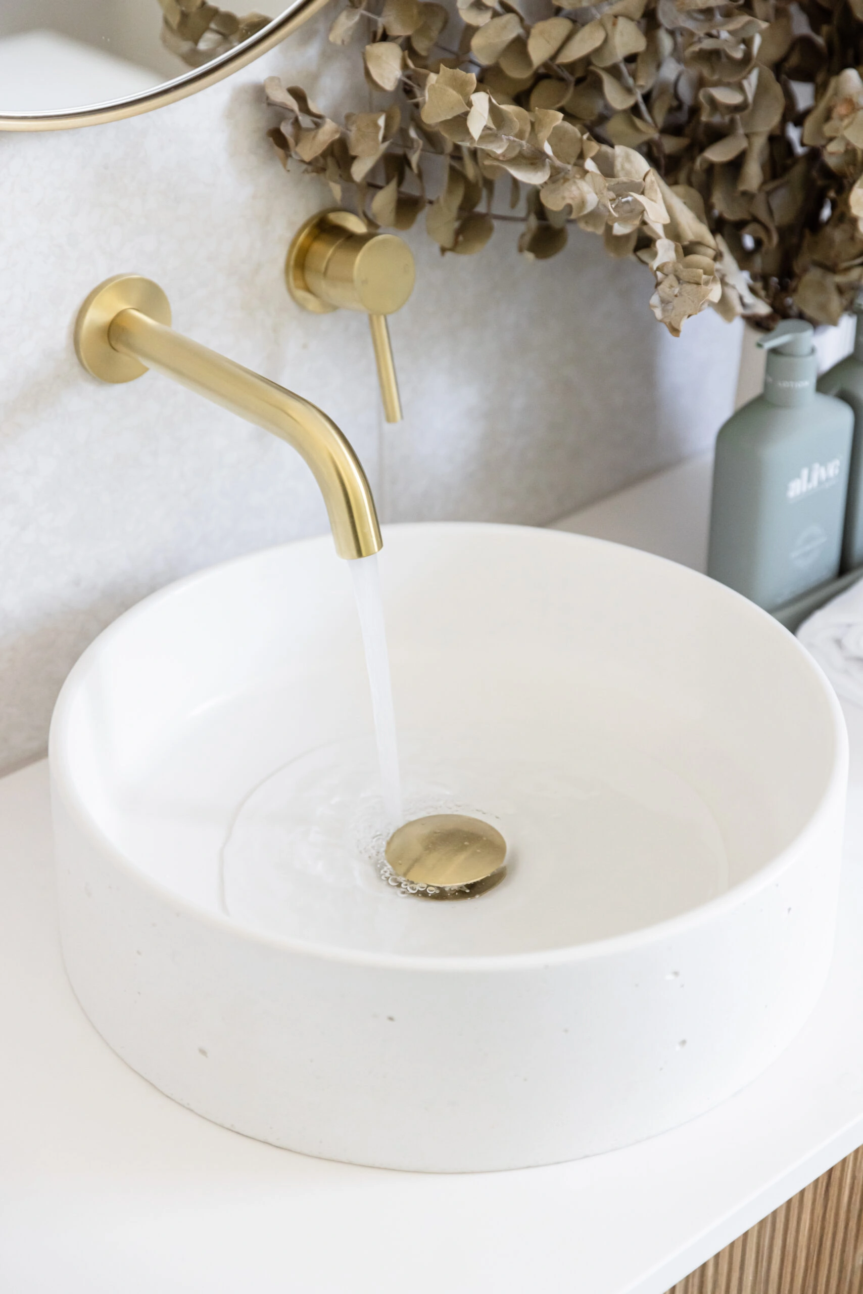 White sink and gold taps in bathroom renovation