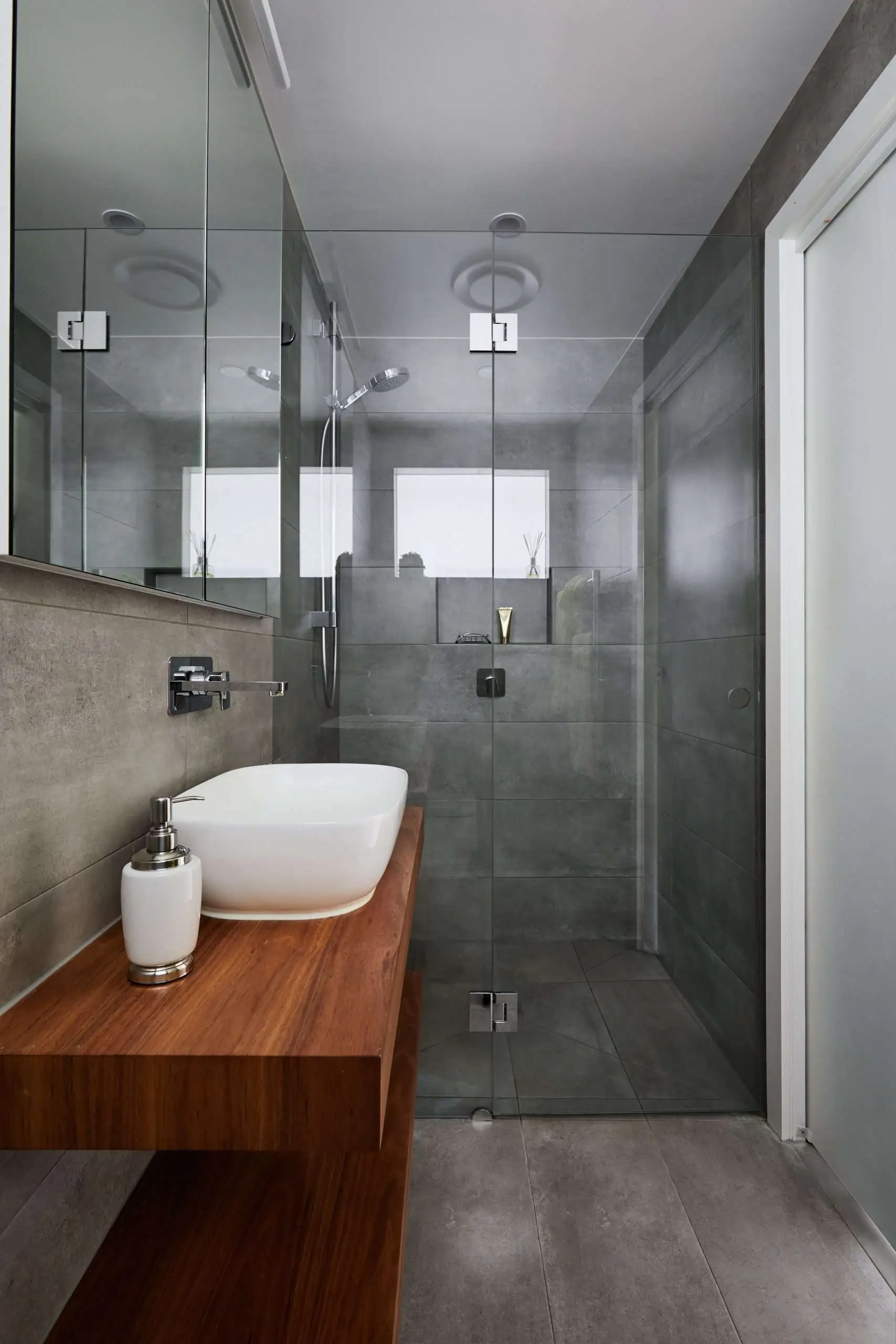 modern grey bathroom with glass shower screen