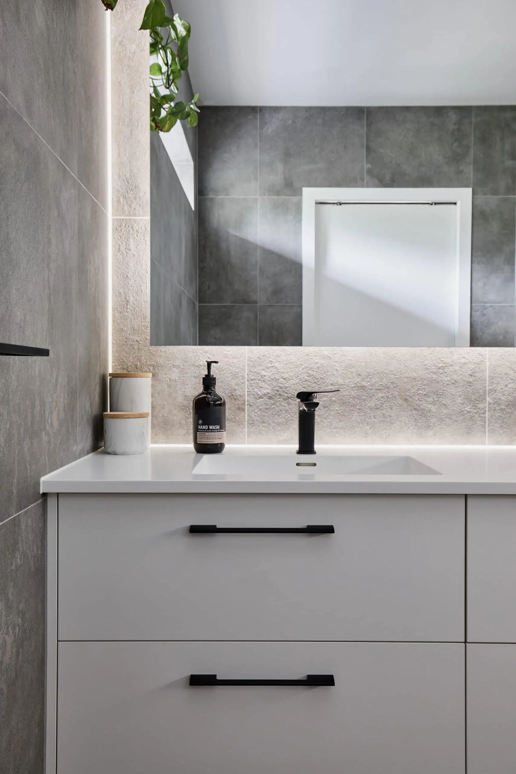 Natural wall tiles and white modern aesthetic in a bathroom photograph