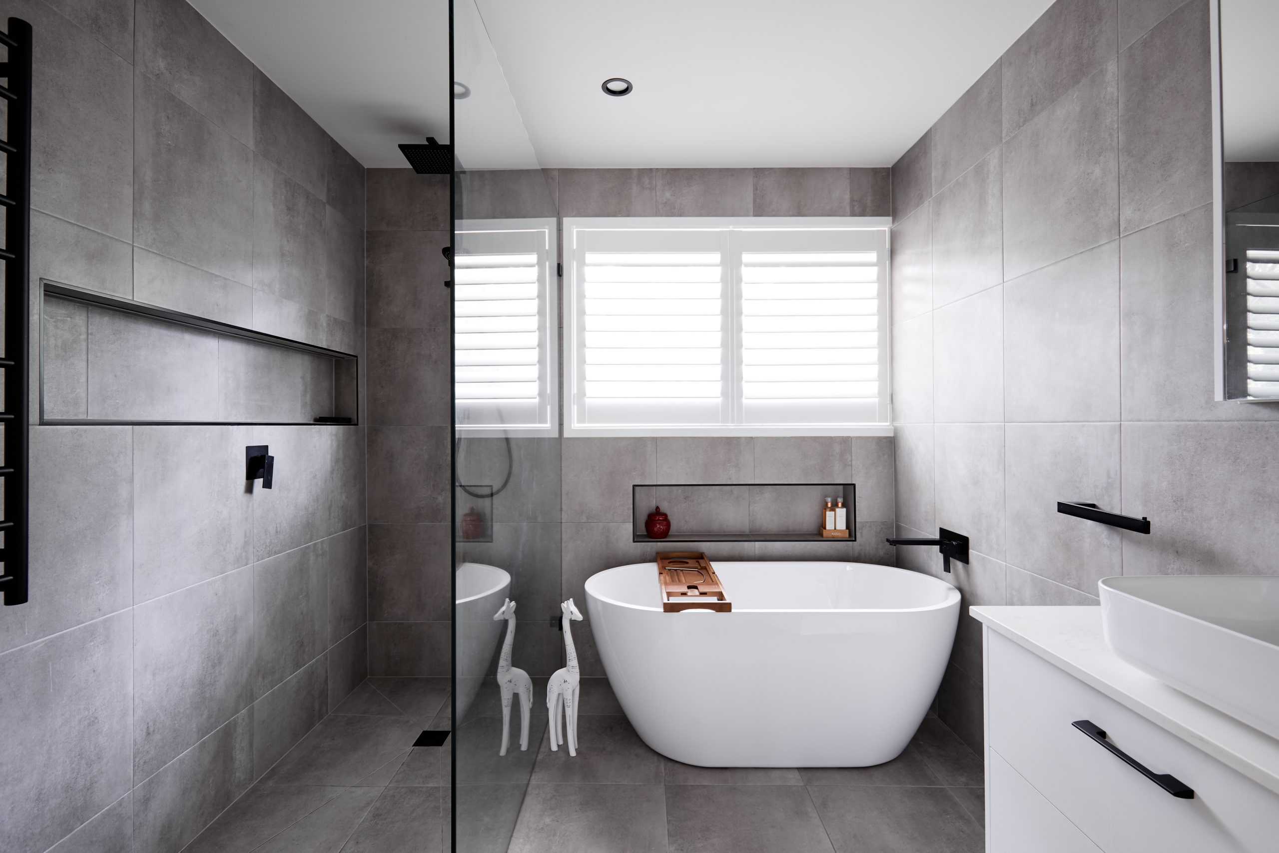 Modern bathroom with white bath and large shower niche
