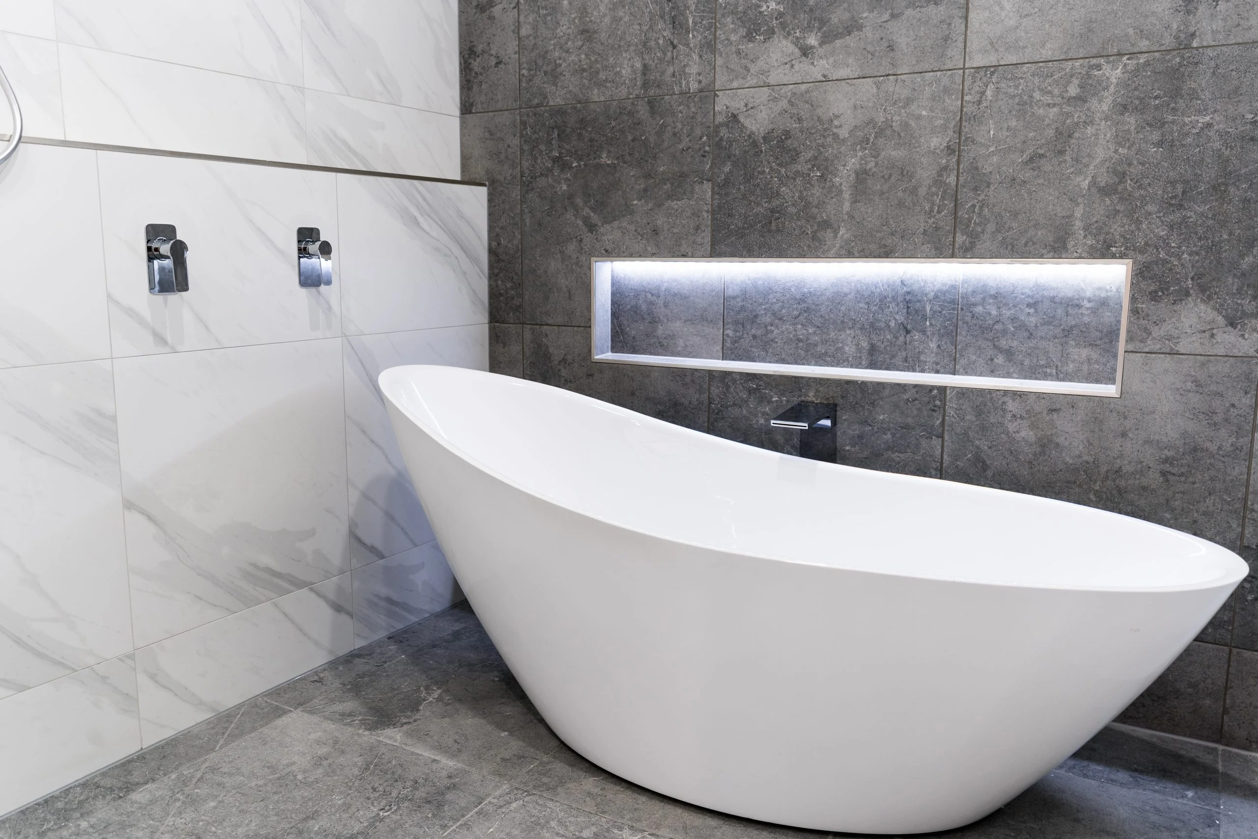 Modern white bath in a bathroom renovation after photo